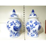 A PAIR OF 20TH CENTURY BLUE & WHITE CHINESE LIDDED VASES, DECORATED WITH FLOWERS AND LEAVES - 48