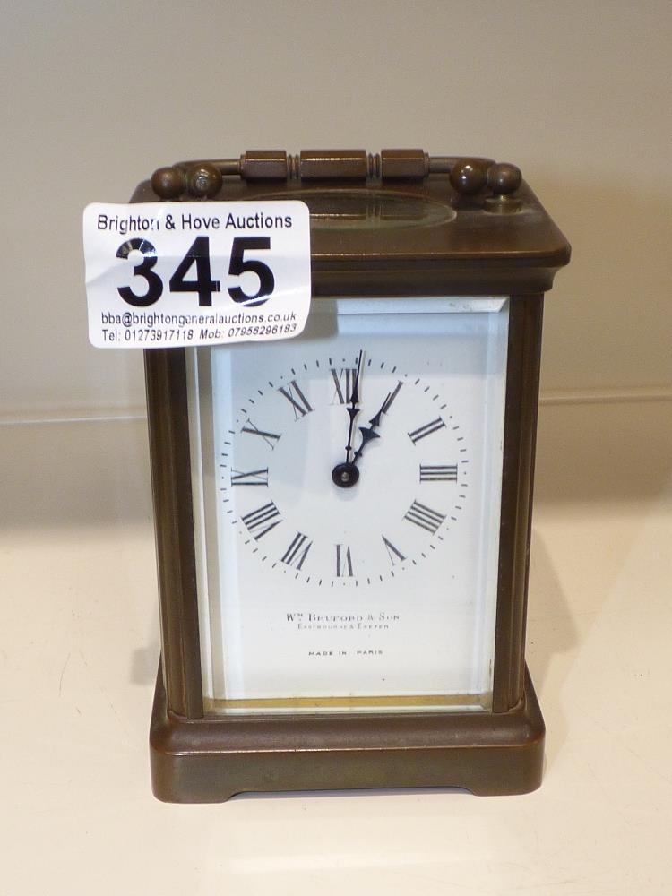 A BRASS CASED CARRIAGE CLOCK, BY W.M BRADFORD AND SONS, MADE IN PARIS, 12 CM TALL