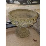 A LARGE RECONSTITUTED STONE WATER FEATURE ON A RAISED PEDASTAL BASE, 54 CM IN DIAMETER, 50 CM TALL