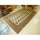 A MIDDLE EASTERN BROWN AND BEIGE PATTERNED RUG 244CM BY 156CM