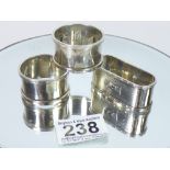 A GROUP OF THREE HALL MARKED SILVER NAPKIN RINGS, 64g