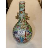 AN ORIENTAL CERAMIC VASE OF BALUSTER FORM DECORATED WITH POLYCHROME ENAMEL. 25CM HIGH