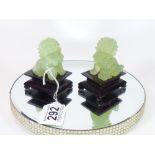 TWO JADE ORIENTAL DOGS OF FO, RAISED ON WOODEN BASES, 8.5CM TALL INCLUDING BASE