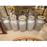 FIVE FRENCH ALUMINIUM MILK CHURNS WITH LIDS