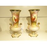 A PAIR OF CROWN DEVON TWIN HANDLED URN / VASES, HAND PAINTED SCENE OF PHEASANTS IN A WOODLAND,