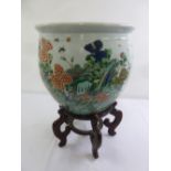 Chinese ceramic fish bowl decorated with flowers and leaves on hardwood stand, 45.5cm diameter, 66