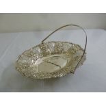 A silver fruit basket, shaped oval with pierced sides and chased flower, leaves and swags, swing