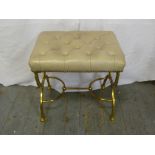 A 20th century rectangular leather upholstered stool on scrolling brass supports