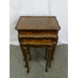 A nest of three walnut tables on cabriole legs