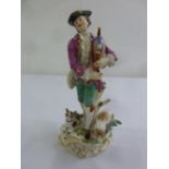 Meissen figurine of a shepherd playing bagpipes with a dog and lamb, marks to side, A/F, 25.5cm (h)