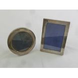 A rectangular hallmarked silver photograph frame and circular hallmarked silver photograph frame