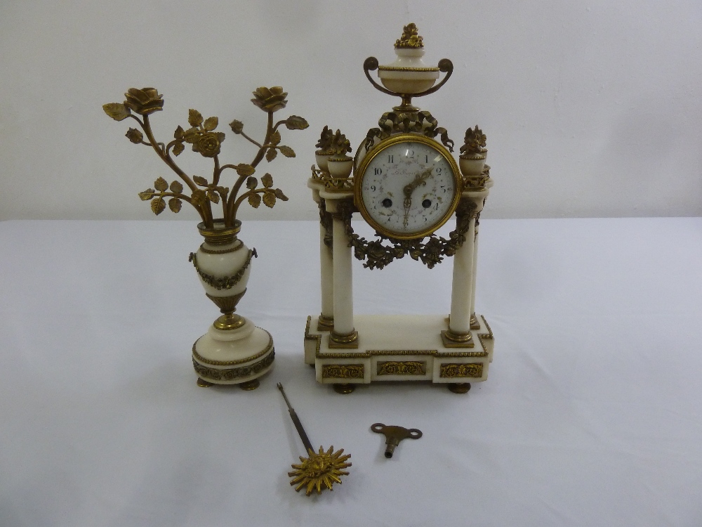 A French white marble and gilt metal mantle clock to include a single garniture, key and pendulum