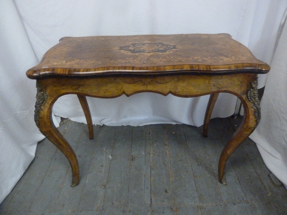 A Victorian rectangular walnut card table, inlaid hinged top on four cabriole legs