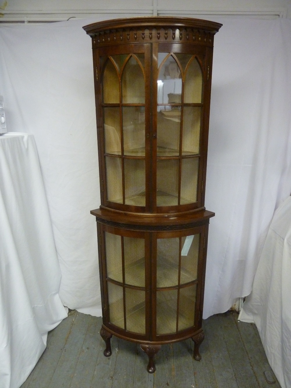 A Victorian mahogany double door glazed breakfront bow fronted corner cabinet