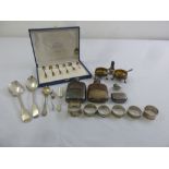 A quantity of silver and white metal to include salts, napkin rings, spoons and cased coffee