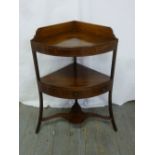 A 19th century mahogany corner wash stand with three drawers and three outswept legs