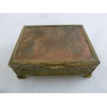 A rectangular gilded metal musical jewellery casket with hinged cover on four bracket feet