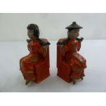 A pair of Oriental ceramic bookends in the form of seated figures