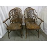 A set of four oak wheel back armchairs