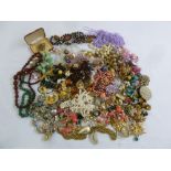 A quantity of costume jewellery to include brooches, pendants, earrings, necklaces