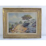A framed oil on board of a landscape indistinctly signed, 42.5 x 59.5cm
