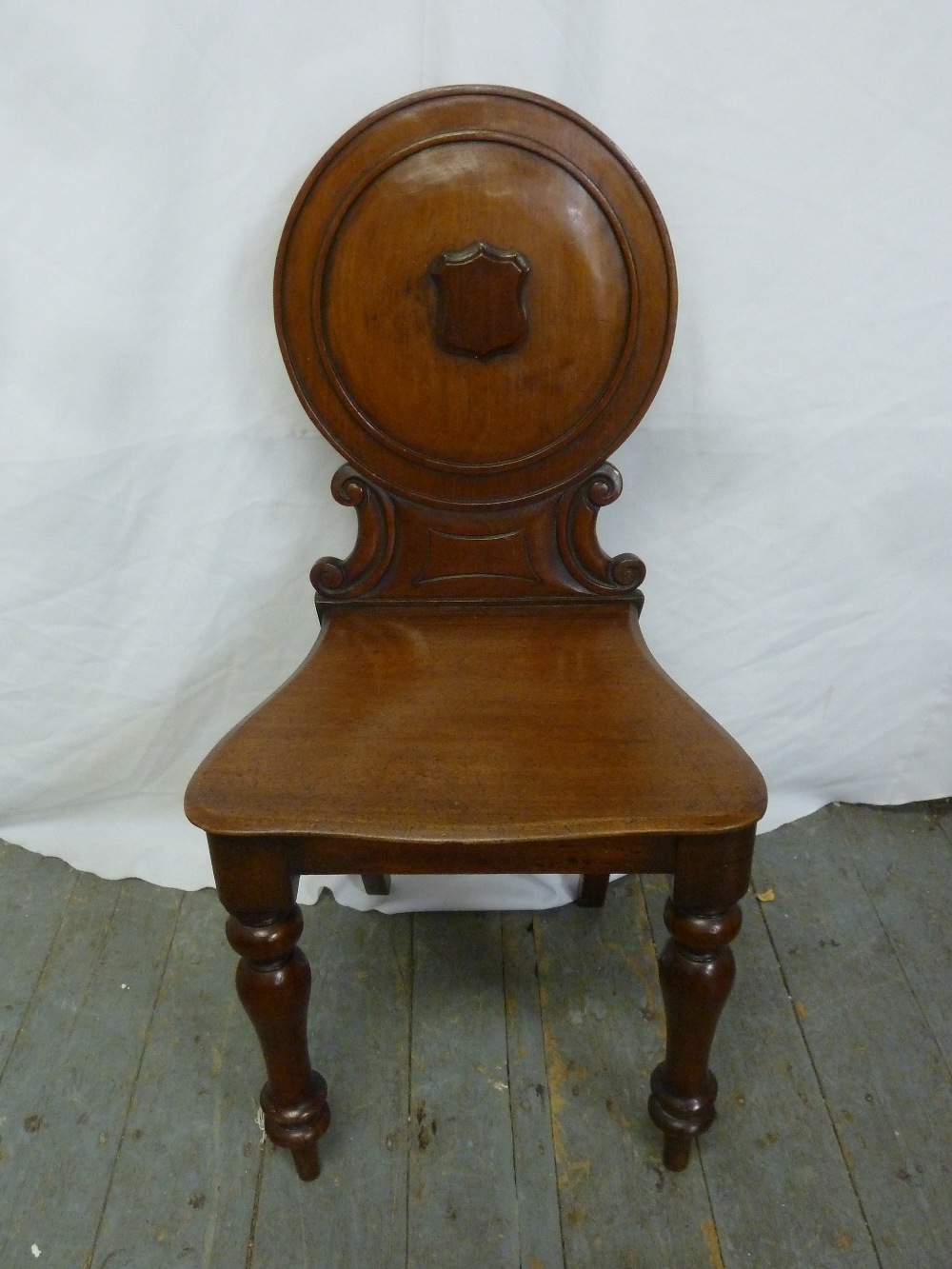 A Victorian mahogany hall chair on four turned legs