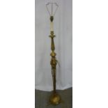 A brass standard lamp of knopped cylindrical form on raised circular base with three lion claw feet