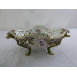 A continental oval porcelain jardinière, the pierced sides decorated with flowers and leaves,