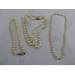 Three strands of pearls one with 9ct gold clasp