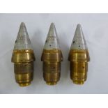 Three paperweights in the form of disarmed missile warheads