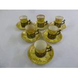 A set of six coffee cups and saucers with pierced silver mounts