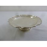 A silver cake stand circular, scroll border on raised circular foot, Sheffield 1923