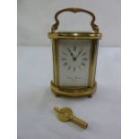 Charles Frodsham of London brass carriage clock, shaped oval, white enamel dial with Roman