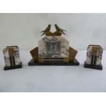 An Art Deco marble clock set surmounted by birds all on rectangular marble bases