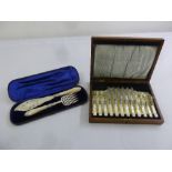 A cased set of fish servers with silver blades and MOP handles and a cased set of fish eaters