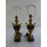 A pair of gilt metal and marble table lamps in the form of classical urns on square marble plinths