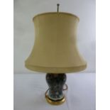 An 19th century baluster form ceramic lamp base with shade