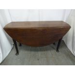 A Victorian mahogany drop flap table on four pad feet and four matching dining chairs with
