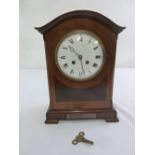 An Edwardian bracket clock, arched top, enamel dial with Roman numerals, two train movement to