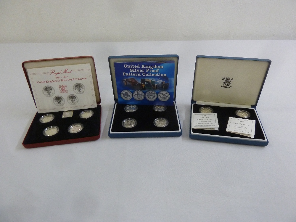 Two four coin £1 proof silver coin sets 1984-1987 and 2003 and a two coin set 2000 and 2003