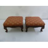 A pair of French upholstered foot stools on four scrolling legs