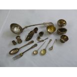 A quantity of silver and white metal to include a ladle, a shoe pin cushion, salts, pepperettes, and