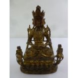 Malaysian gilded metal figurine of a Buddha on raised lobed oval plinth