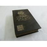 A Chinese hardbound book with inset jade panels and gilded characters and letters