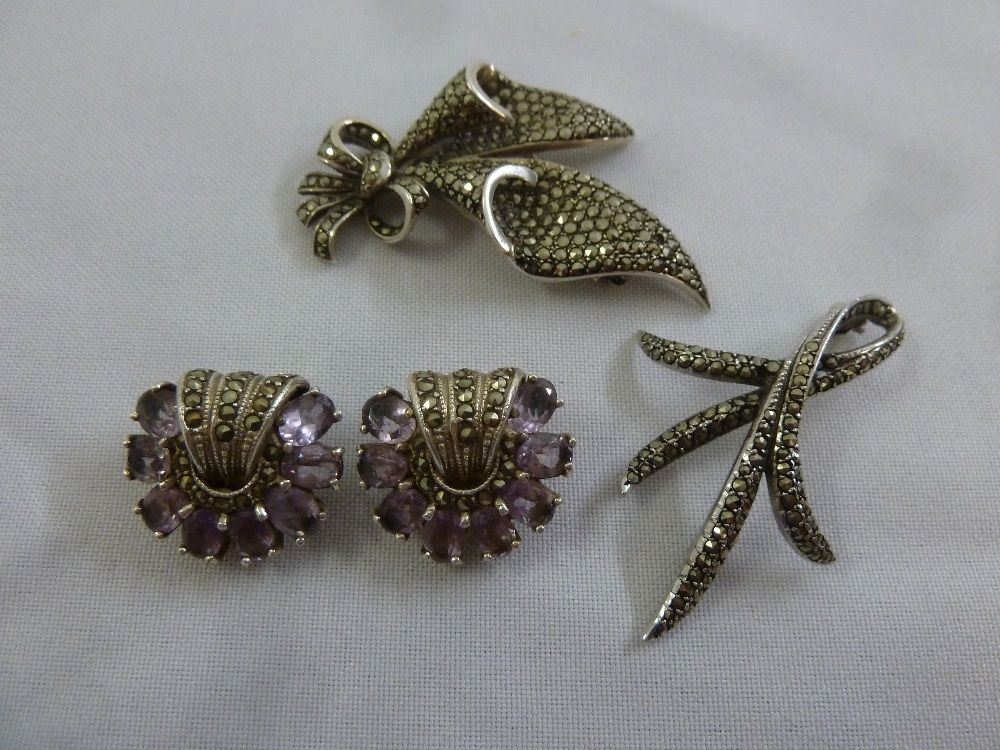 A pair of antique silver and coloured stone earrings and two marcasite brooches