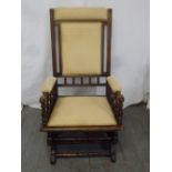 An early 20th century upholstered rocking chair