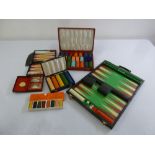A quantity of gaming chips, bridge cards, a travel backgammon set and another
