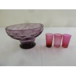 An amethyst glass fruit bowl and three cranberry glass beakers
