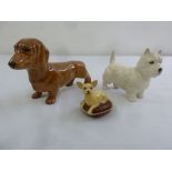 Three Beswick figurines of dogs to include a Dachshund, a Westie and a Chihuahua