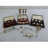 A quantity of silver to include cased teaspoons, three Kiddush cups and a knife rest